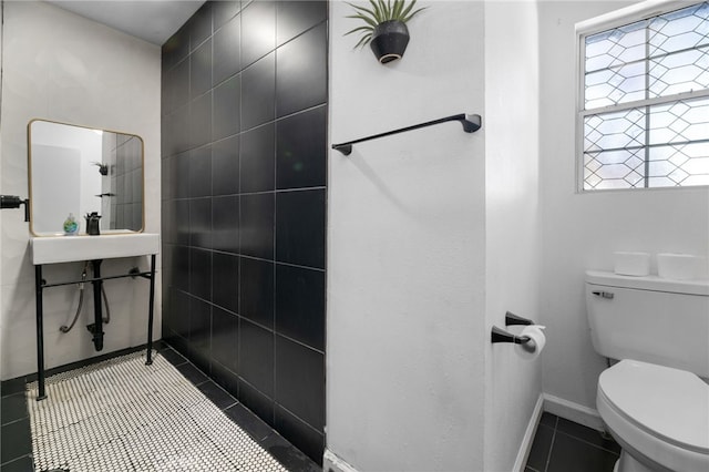 bathroom with toilet and tile patterned floors