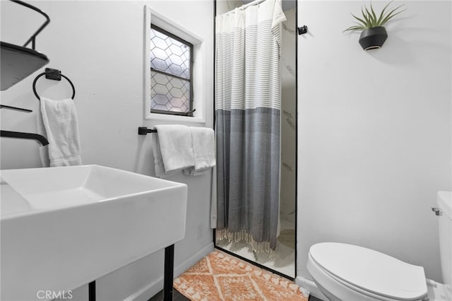 bathroom featuring walk in shower and toilet