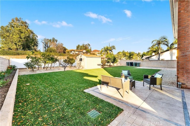 view of yard featuring a patio area, an outdoor living space, and a shed