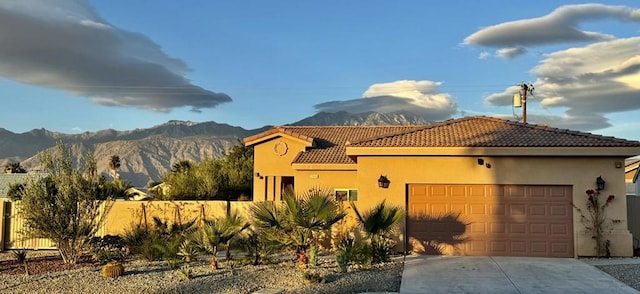 view of front of house with a mountain view and a garage