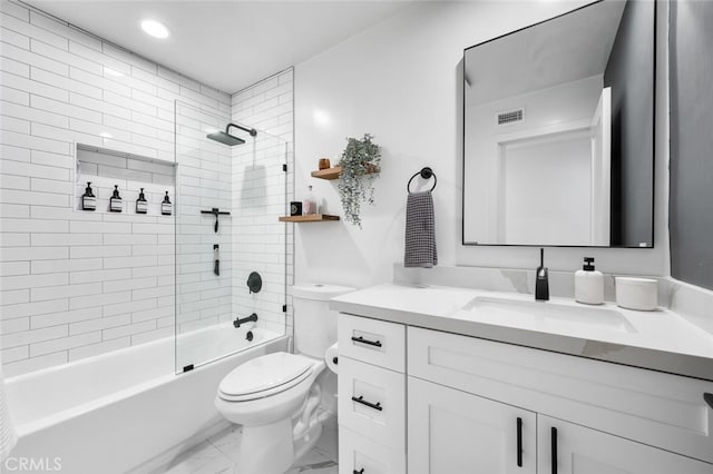 full bathroom with tiled shower / bath combo, vanity, and toilet