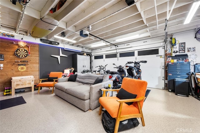 garage featuring a garage door opener and wood walls