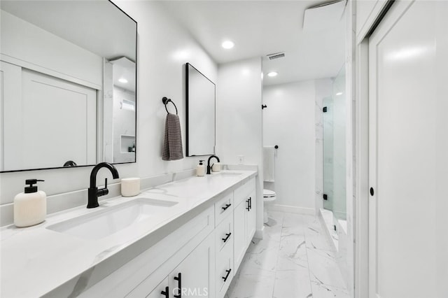 bathroom featuring walk in shower, vanity, and toilet