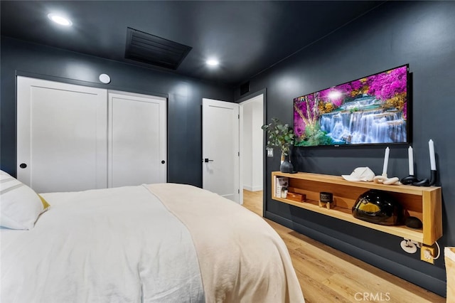 bedroom with hardwood / wood-style flooring and a closet