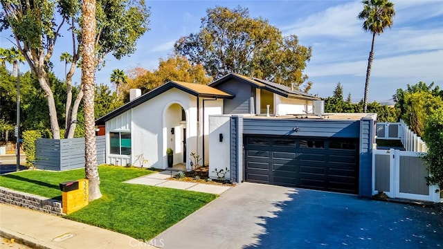 contemporary house with a garage and a front yard