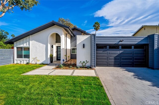 view of front of home with a garage and a front yard