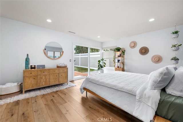 bedroom featuring access to exterior and hardwood / wood-style floors