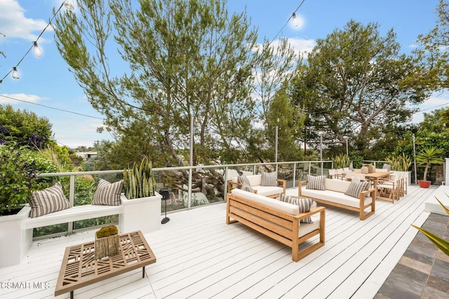 wooden terrace featuring an outdoor living space