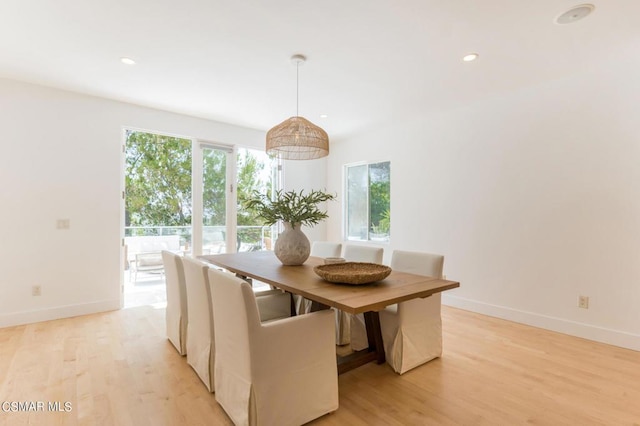 unfurnished dining area featuring light wood-type flooring