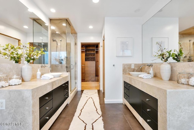 bathroom featuring a shower with door, vanity, and tile patterned flooring