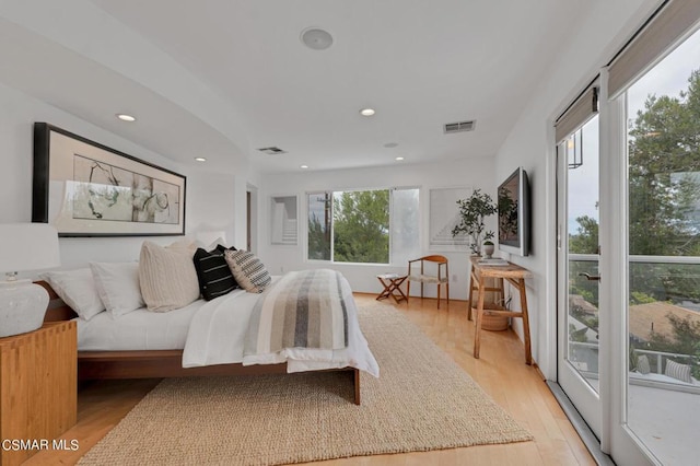 bedroom with light wood-type flooring and access to outside