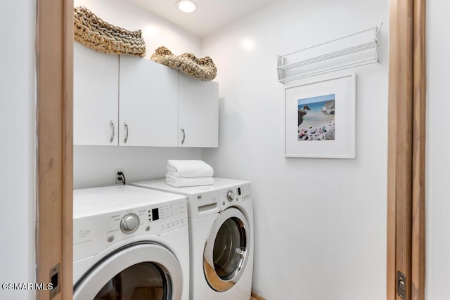 laundry area with cabinets and washing machine and clothes dryer