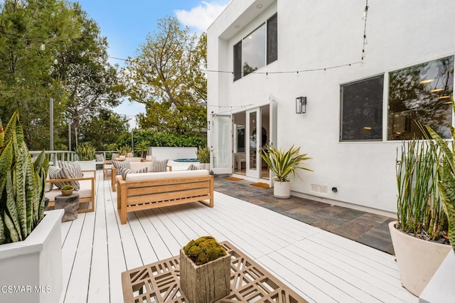 deck featuring an outdoor hangout area and french doors