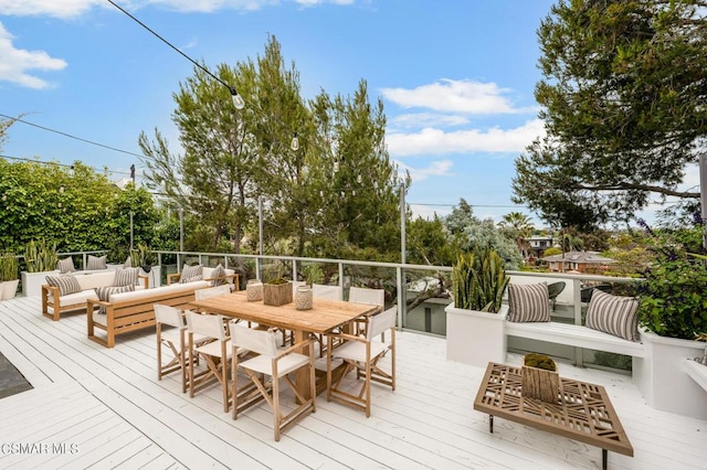 wooden terrace with an outdoor living space