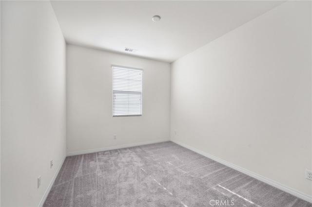 unfurnished room with light colored carpet