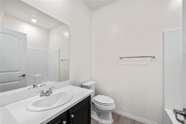 bathroom with wood-type flooring, toilet, and vanity