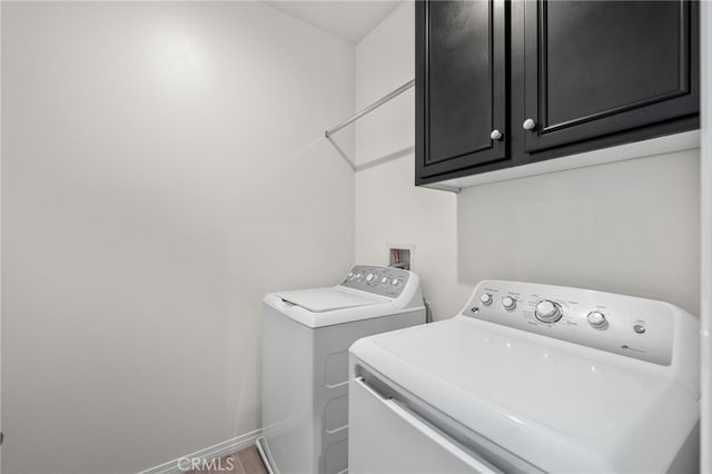 laundry room with cabinets and separate washer and dryer