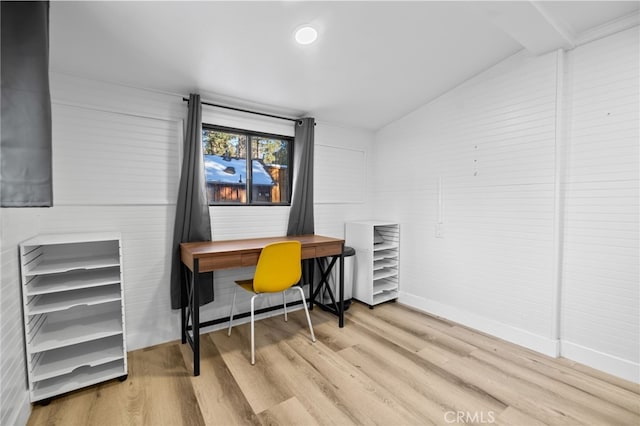 home office featuring vaulted ceiling and wood-type flooring