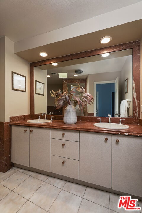 bathroom with tile patterned flooring and vanity