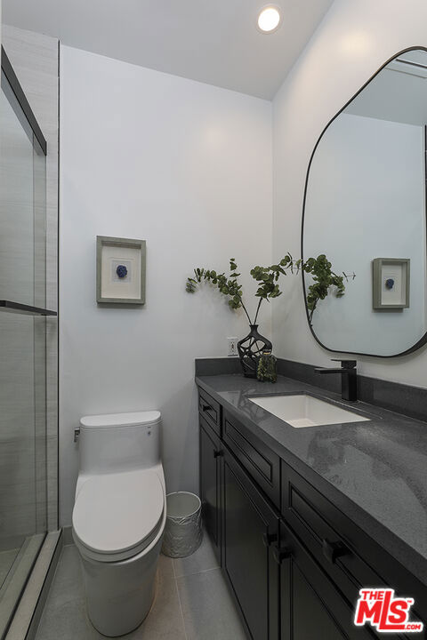 bathroom featuring tile patterned floors, toilet, and vanity