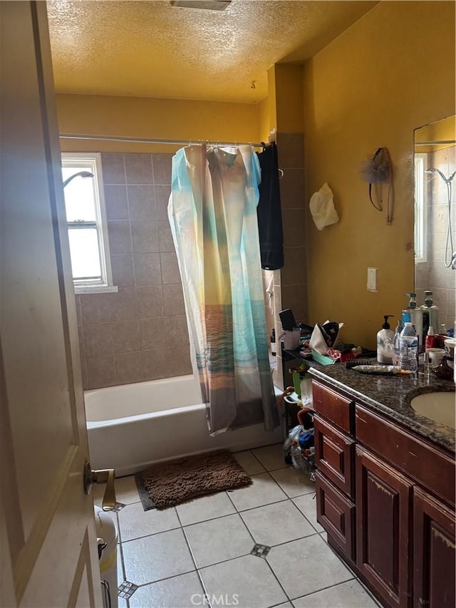 bathroom with a textured ceiling, tile patterned floors, vanity, and shower / bath combination with curtain