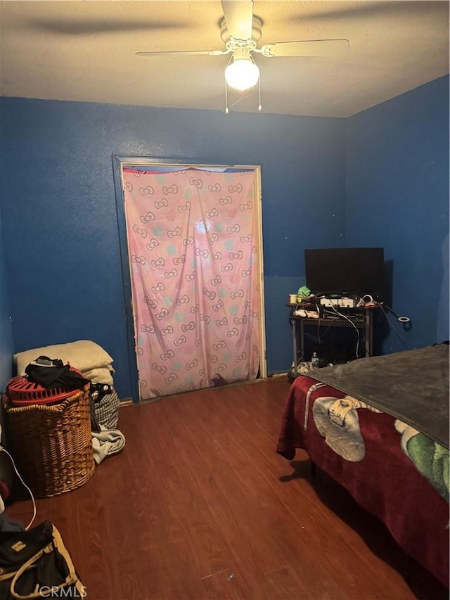 bedroom featuring ceiling fan and wood-type flooring