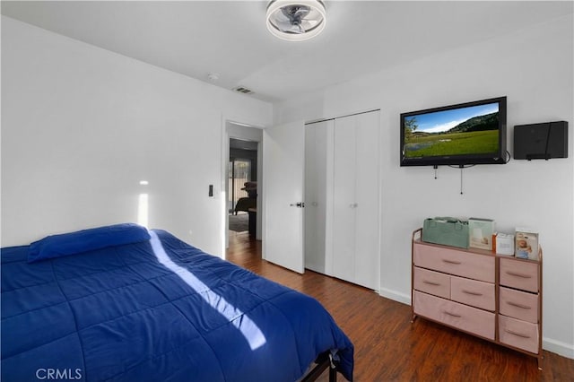 bedroom with a closet and dark wood-type flooring