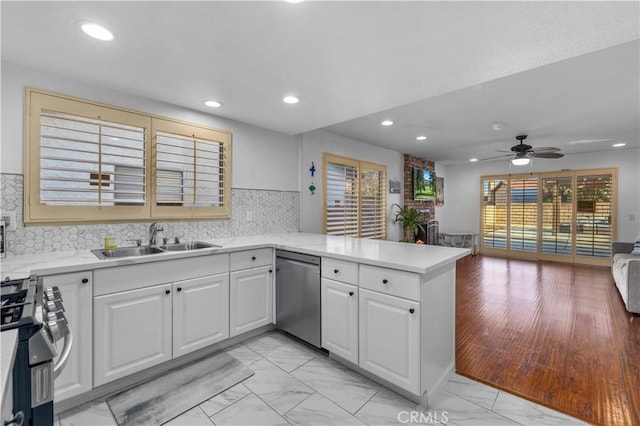 kitchen featuring white cabinetry, kitchen peninsula, ceiling fan, appliances with stainless steel finishes, and sink