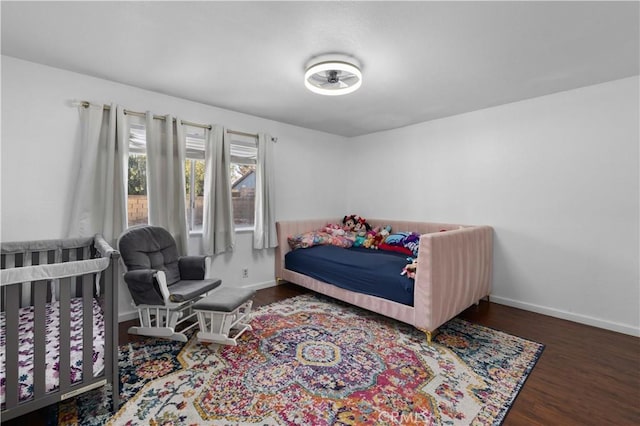 bedroom with dark wood-type flooring