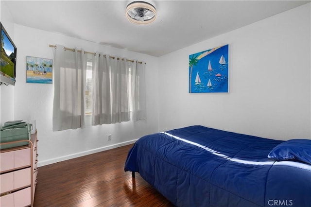 bedroom with dark hardwood / wood-style flooring