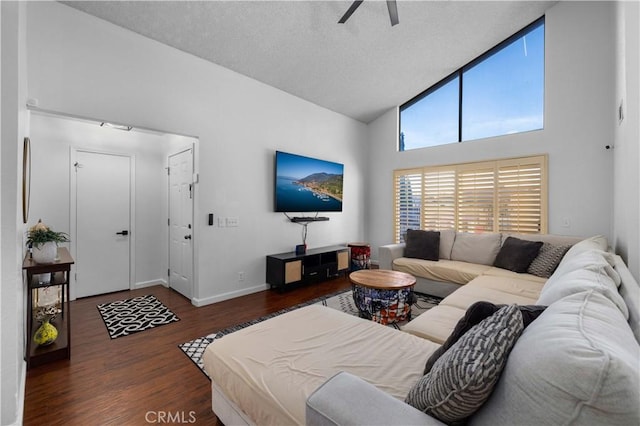 living room featuring ceiling fan, dark hardwood / wood-style floors, and high vaulted ceiling