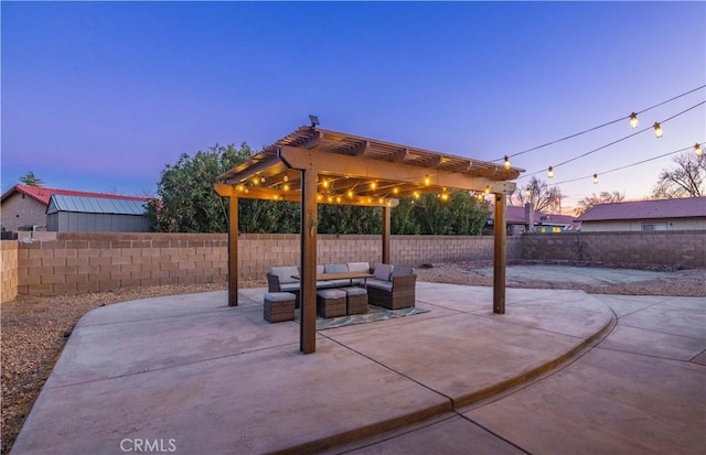 patio terrace at dusk featuring an outdoor living space