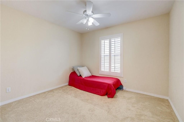 bedroom with light carpet and ceiling fan