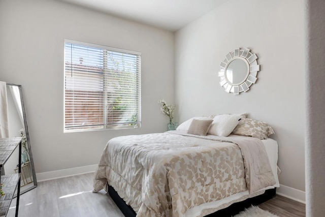 bedroom with hardwood / wood-style floors