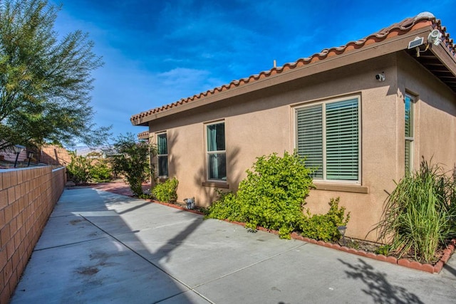 view of side of home featuring a patio