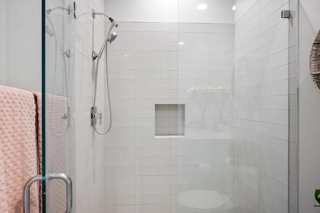 bathroom featuring toilet and an enclosed shower