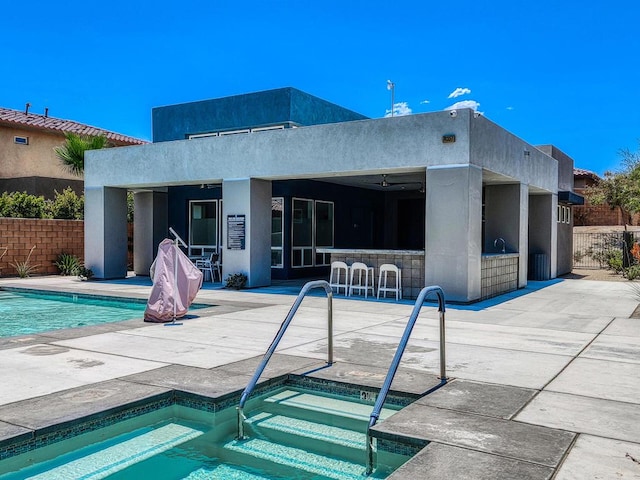 view of pool with a jacuzzi and a patio