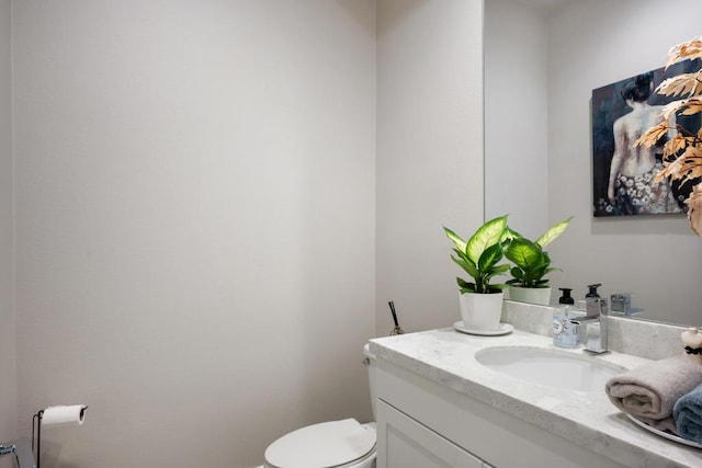 bathroom with toilet and vanity