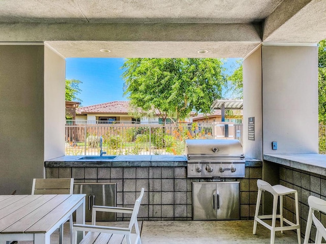 view of patio with a wet bar and grilling area