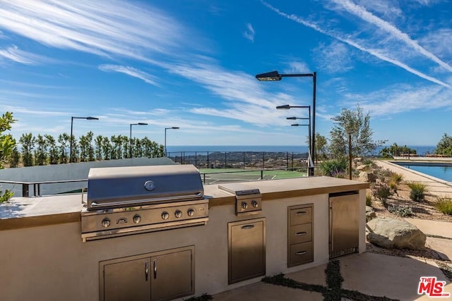 view of patio featuring a pool and grilling area