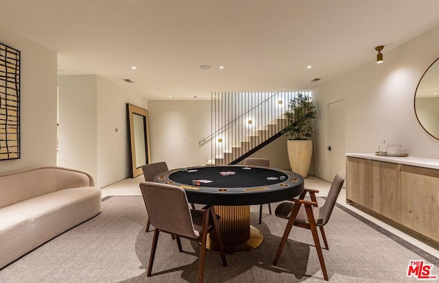 recreation room featuring light carpet and indoor bar