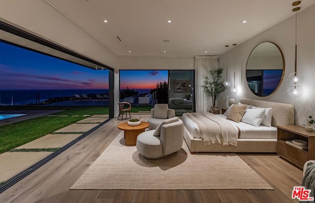 bedroom with light hardwood / wood-style flooring and golf simulator