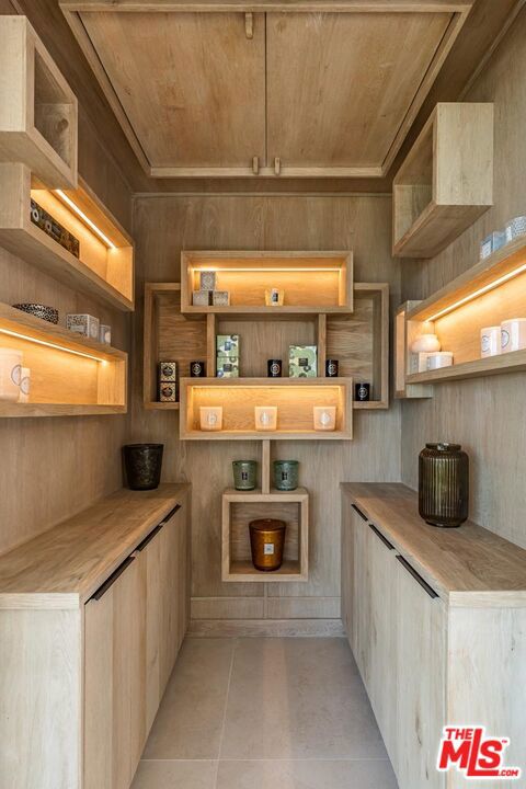 interior space featuring light tile patterned floors and wood ceiling