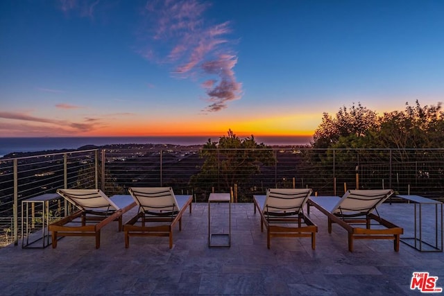 view of patio terrace at dusk