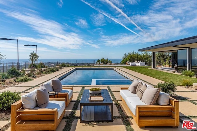 view of swimming pool featuring a water view, an outdoor living space, and a patio area