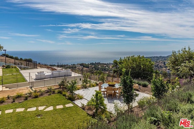 exterior space featuring a patio area and a water view