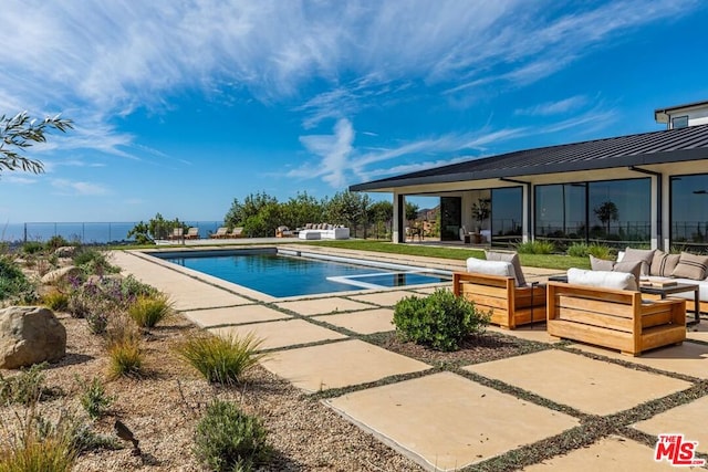 view of pool with outdoor lounge area and a patio