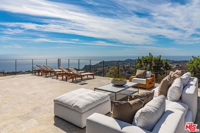 view of patio / terrace with a water view, an outdoor living space, and a grill