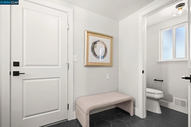 bathroom featuring toilet and tile patterned flooring