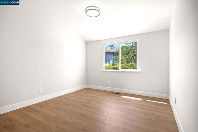 empty room with light hardwood / wood-style flooring